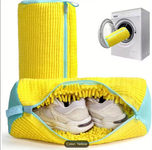 Yellow and turquoise JYNOR shoe washing bag with sneakers beside a washing machine